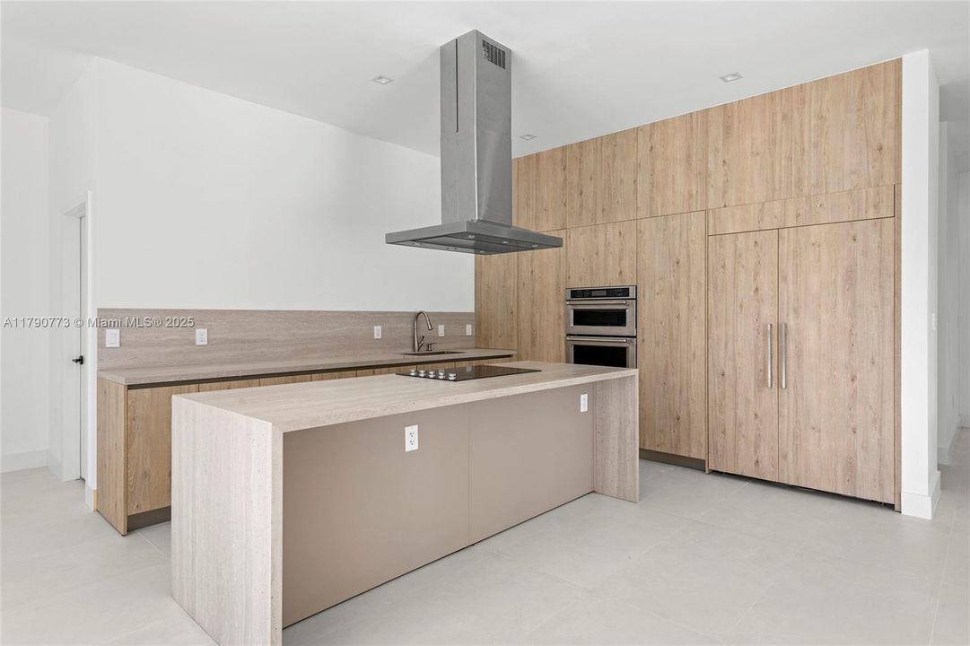 Built-in, panel-ready 48-inch JennAir refrigerator seamlessly integrated into the custom cabinetry, combining high-end performance with sleek, modern design.