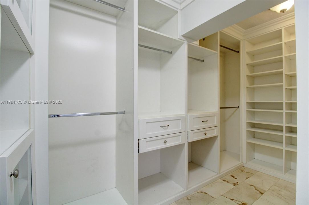 master bedroom walk in closet with built ins