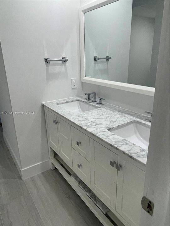 Double sink vanity with MOEN fixtures.