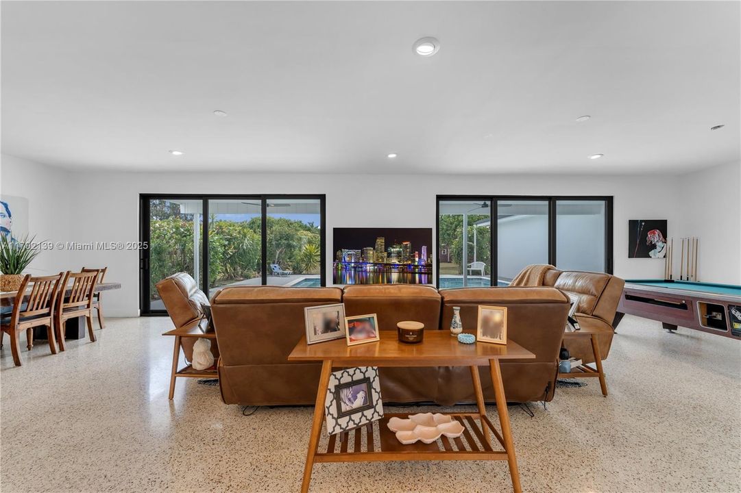 ROOM WITH IMPACT SLIDER'S, A WALL OF GLASS OVERLOOKS POOL AND GROUNDS