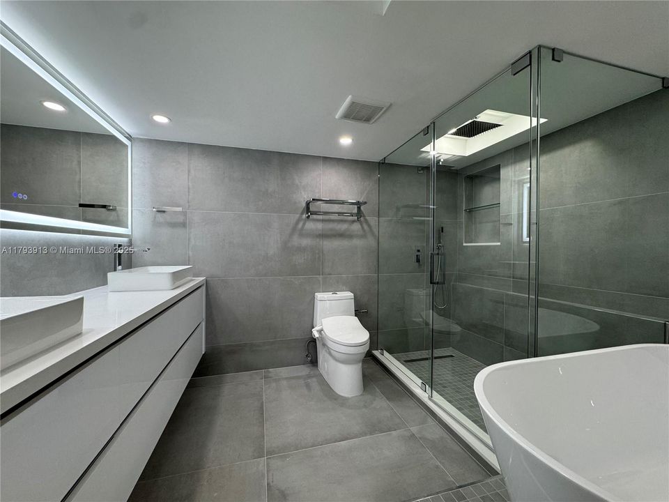 Shower with multiple shower heads, niches, frameless glass enclcosure