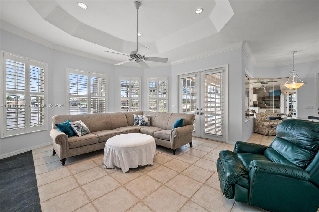 Family Room with Gas fireplace and plantation shuttered windows