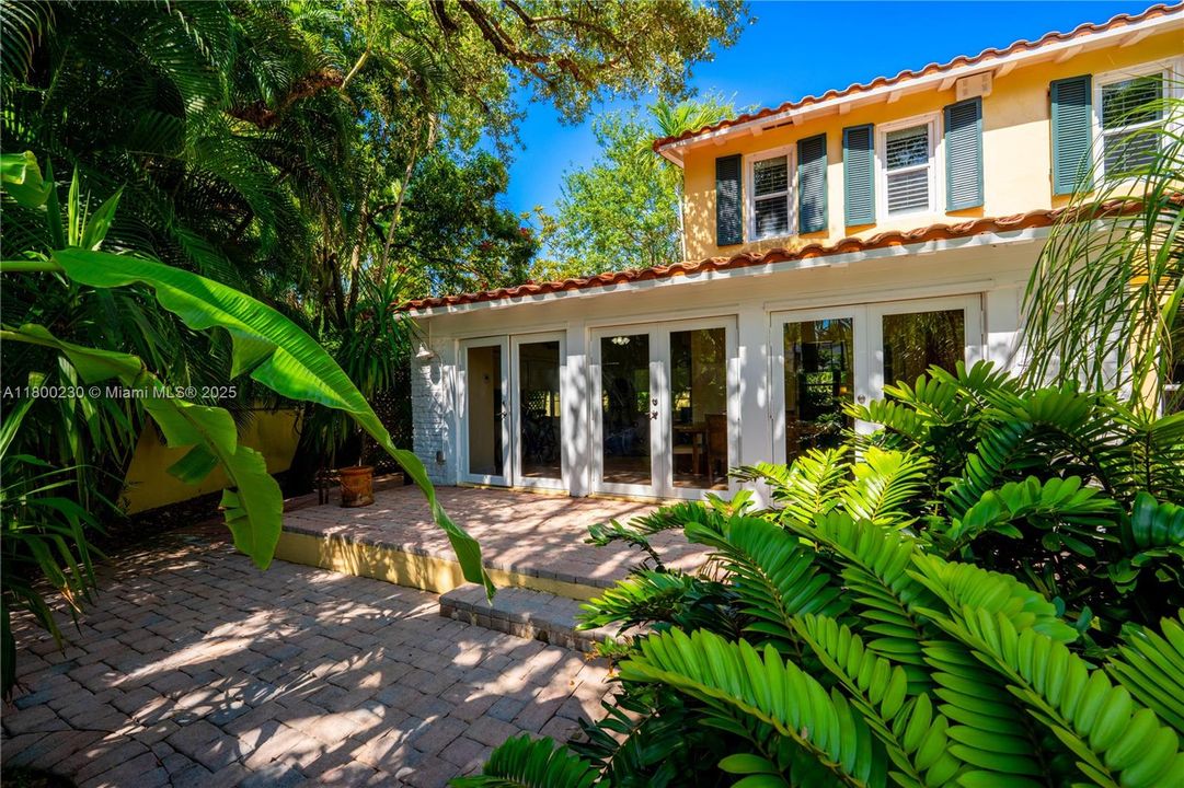 Florida Room's French doors open to the luscious garden