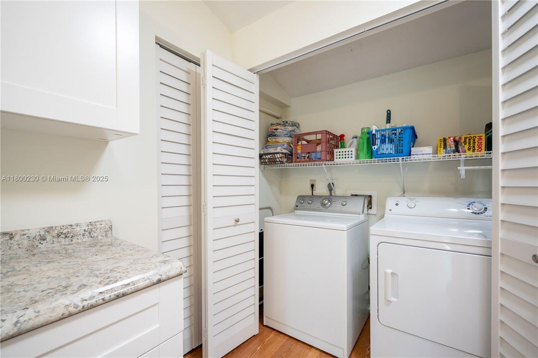 Very large laundry area with cabinetry, an extra refrigerator and lots of closet space