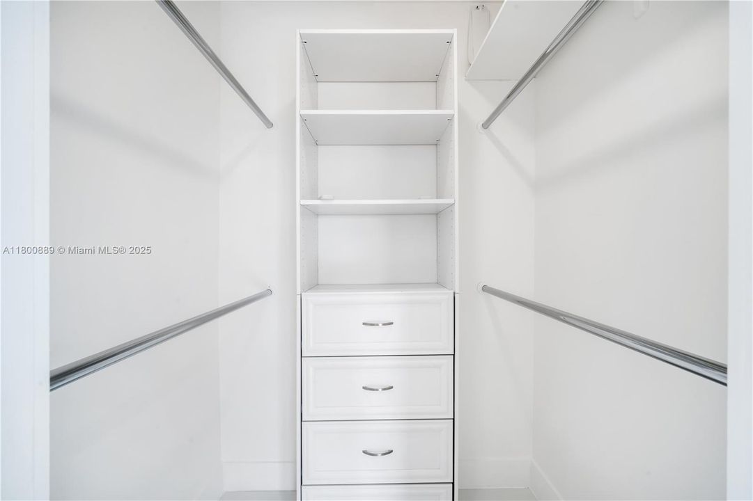 Closet with some built-ins in the west bedroom