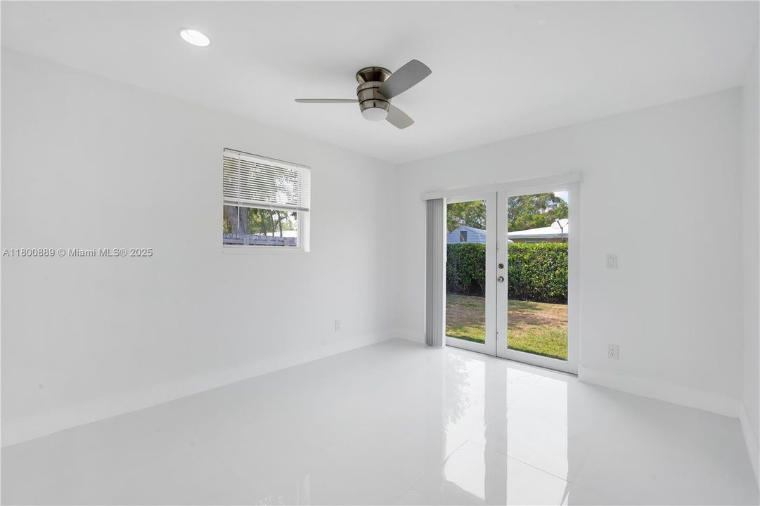 This bedroom has a french door leading out to the backyard.
