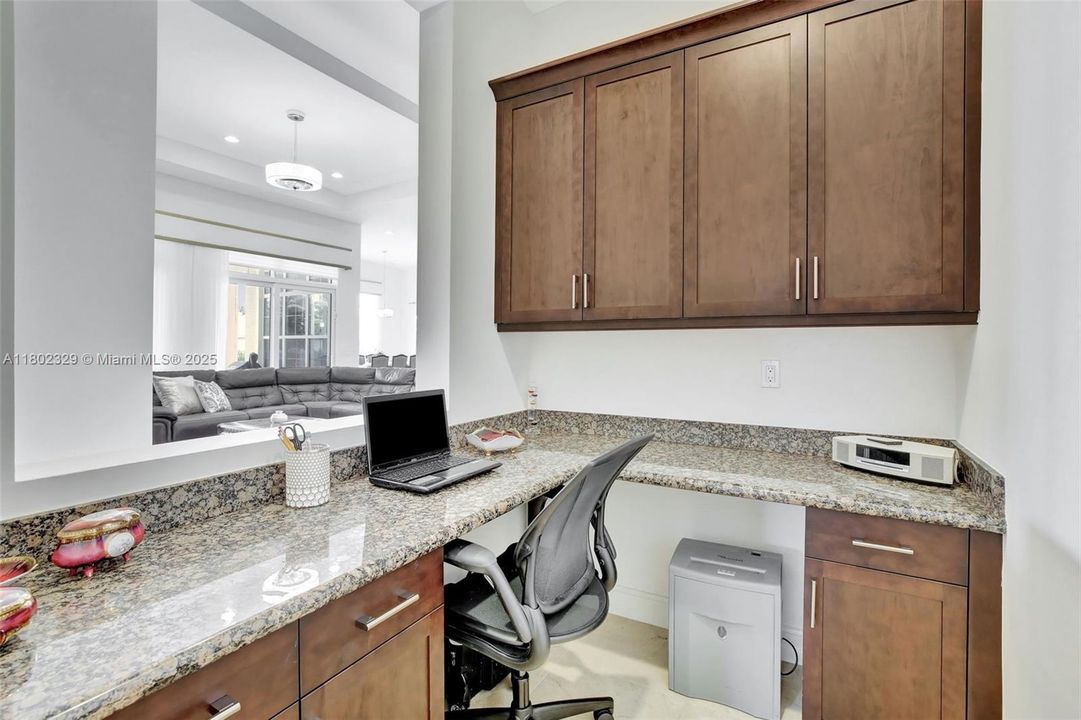 Currently used as additional workstation/office space, but with pass-through opening to living room, could serve as wet bar/entertaining space.  Fit to whatever your specifications or needs
