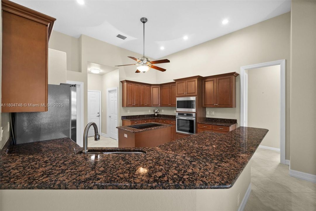 Kitchen with Granite tops and a breakfast bar
