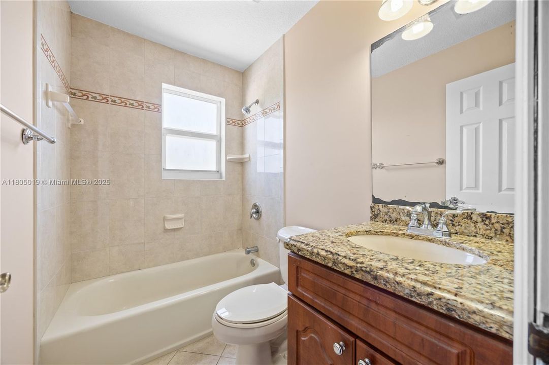 Side backyard that has a small shed for storing handman tools.