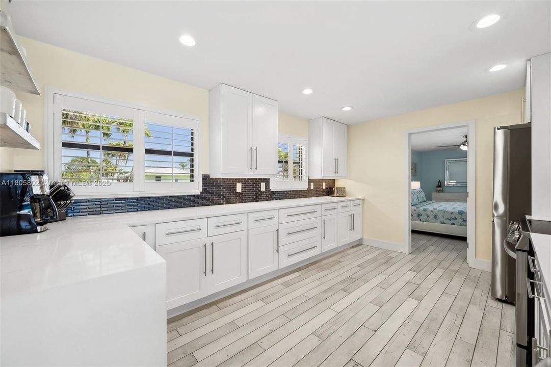 Remodeled kitchen with quartz countertops and waterfall edge
