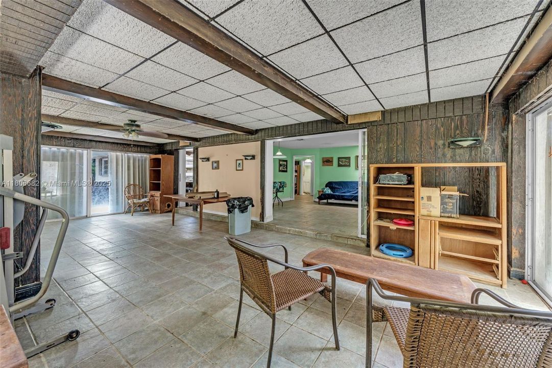 FLORIDA/FAMILY ROOM WITH GREAT NATURAL LIGHTING WITH EXTERIOR ENTRANCES IN ADDITION OPENS INTO LIVING AREA/KITCHEN.