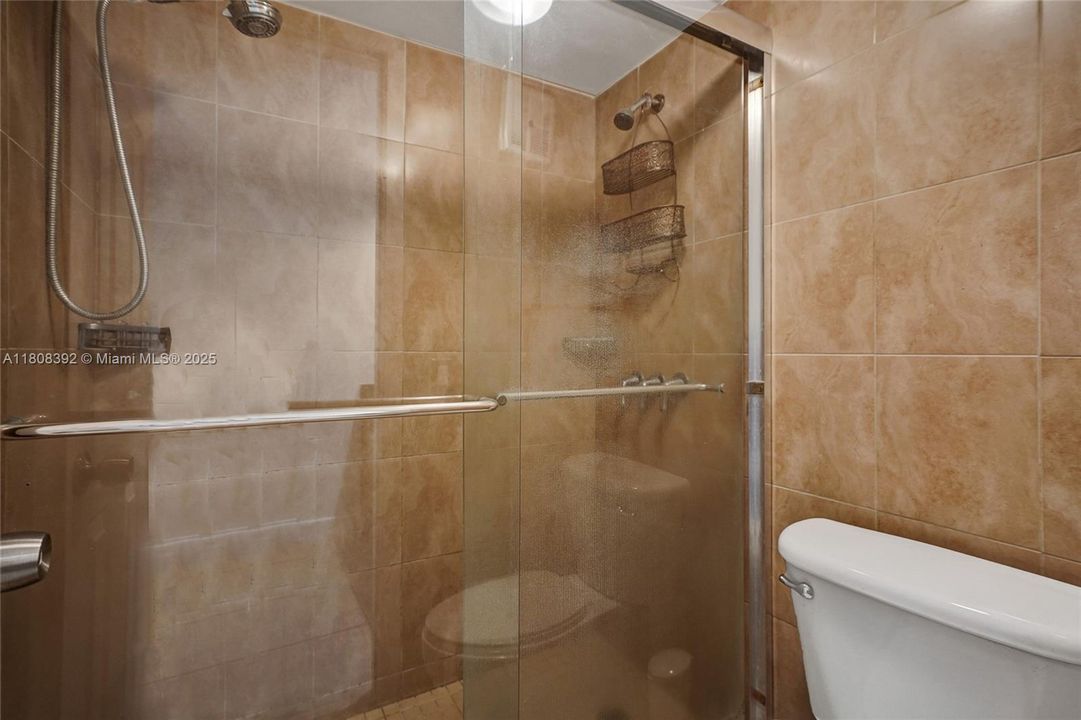 huge shower with sparkling glass door