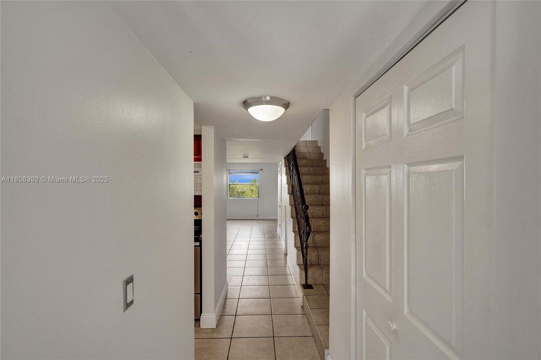 Large washer/dryer on the right, kitchen to the left, huge living/dining rooms and 1/2 bath straight ahead. Neutral tiles throughout AND is larger than most 2nd floor units.