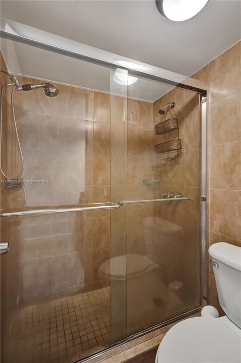 huge shower with sparkling glass door