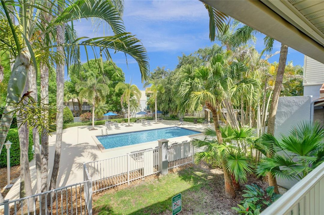 Sparkling pool area features lots of lounge chairs, gazebo with dinng table and chairs, and a grill for those delicious BBQ's. Notice the lush landscaping and meticulously maintained grounds, too.