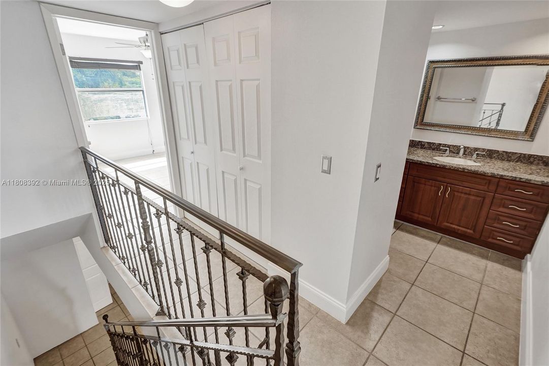 Stairs, 2nd floor landing, and entire 2nd floor has matching neutral tiles just as the 1st floor does.