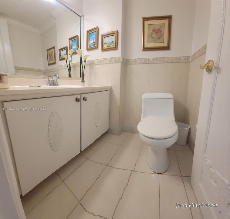 Half bathroom, hall between kitchen and dining room