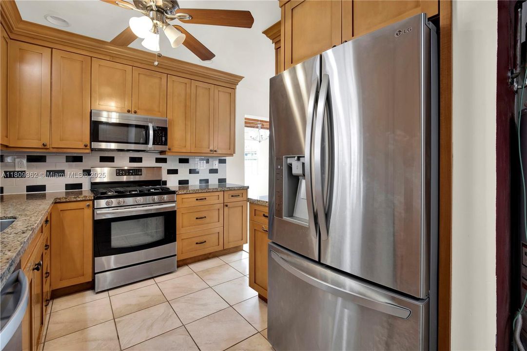 Laundry room with a door to the carport and backyard