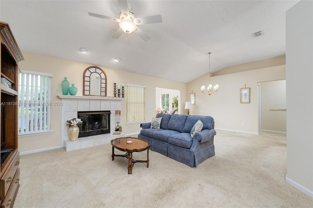 Tiled gas fireplace with wood mantel