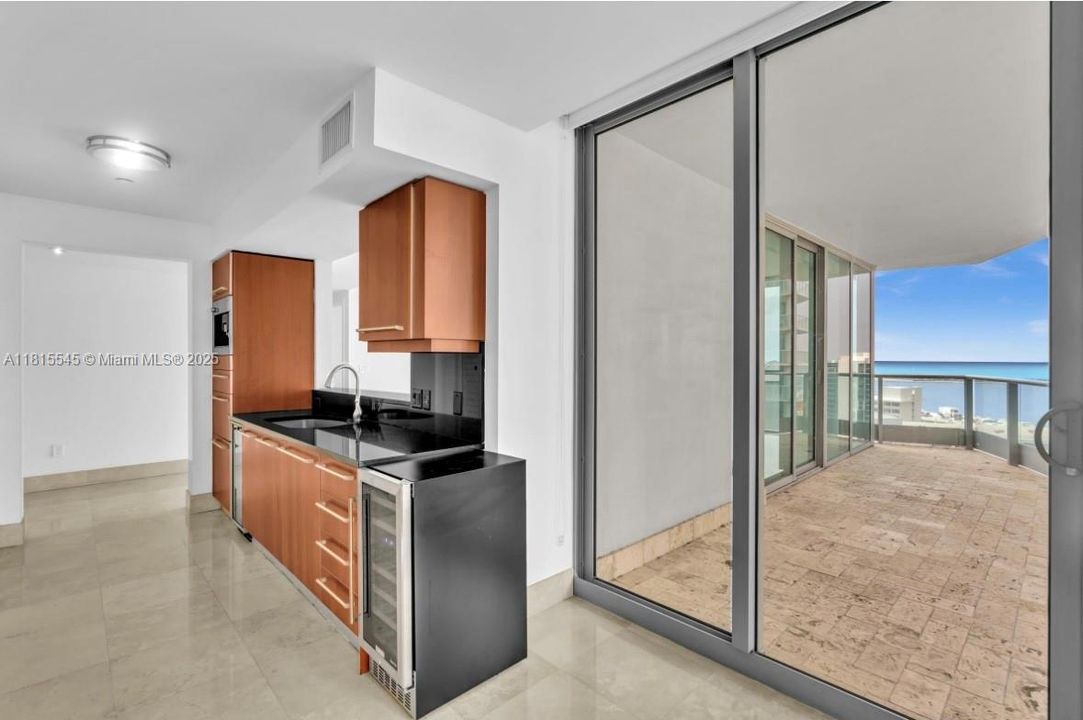 Built-In Coffee Maker, Wall Oven, Microwave/Oven Combo, Electric Cooktop, Vent hood, Sub-Zero Built-In Refrigerator & Freezer, Built-In Wine Cooler, Double Stainless Steel Sink.