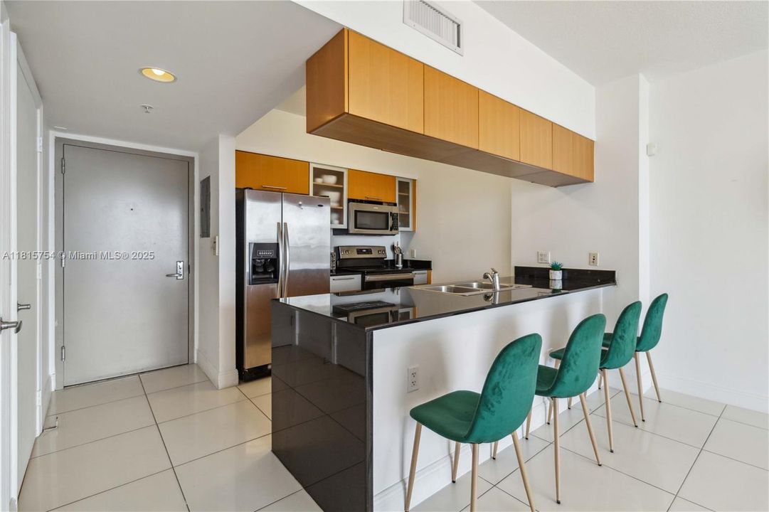 Modern kitchen with sleek cabinetry, stainless steel appliances, and breakfast bar — perfect for cooking with a view.