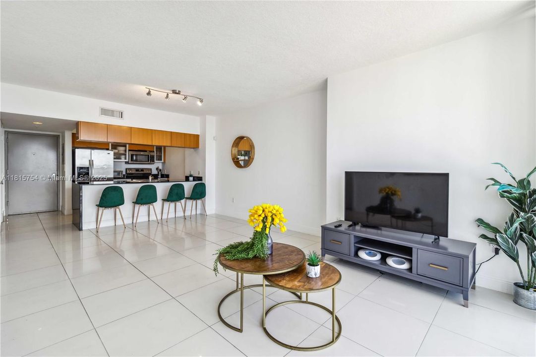 Stylish living space featuring open layout, elegant decor, and seamless connection to the balcony overlooking the Miami skyline.