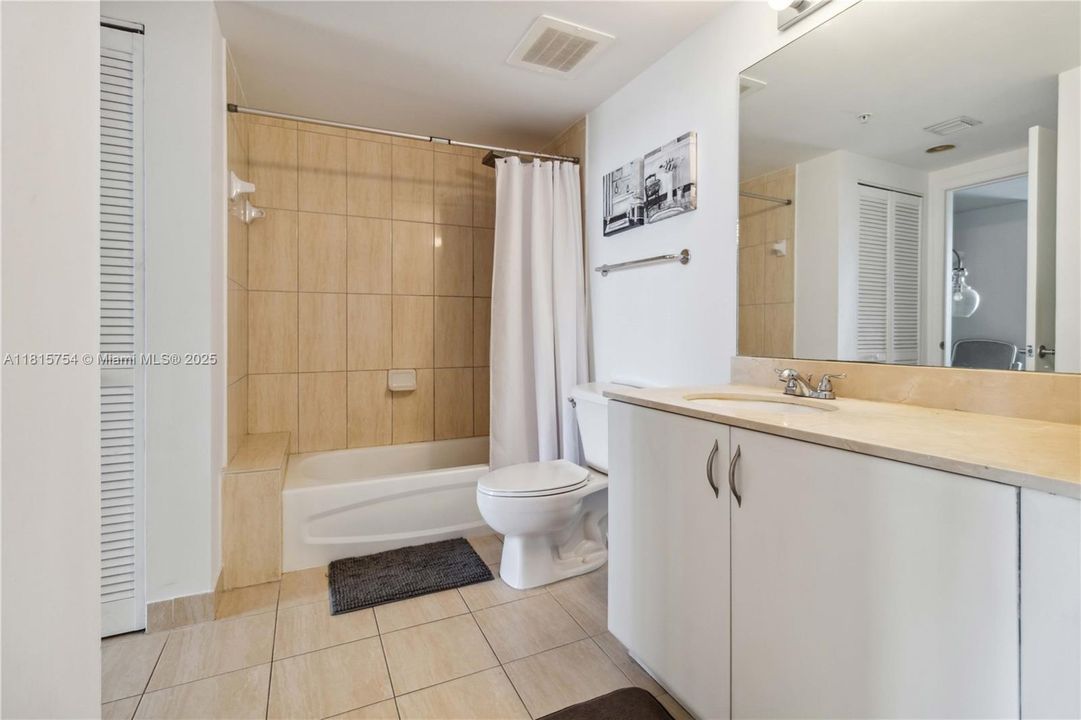 Upgraded bathroom with modern vanity, spacious mirror, and clean finishes — designed for comfort and relaxation.