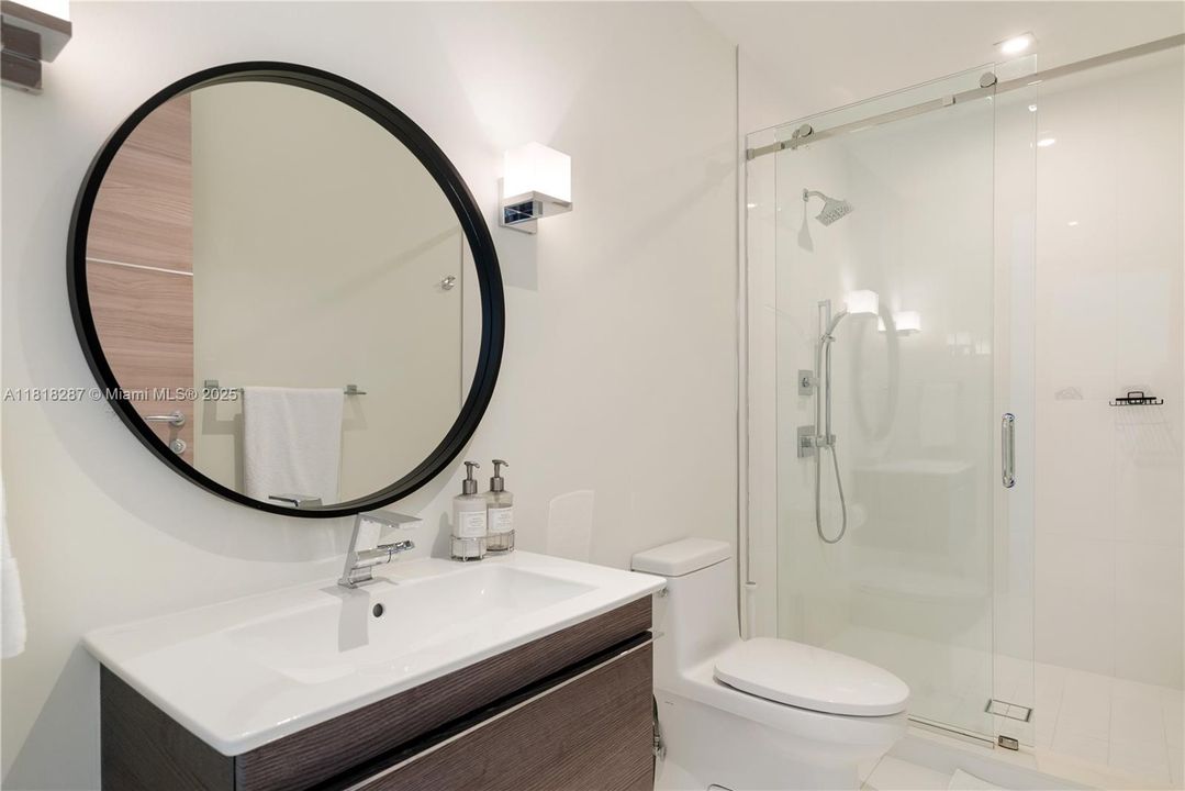 Well-appointed bathroom with walk-in shower and sleek finishes.