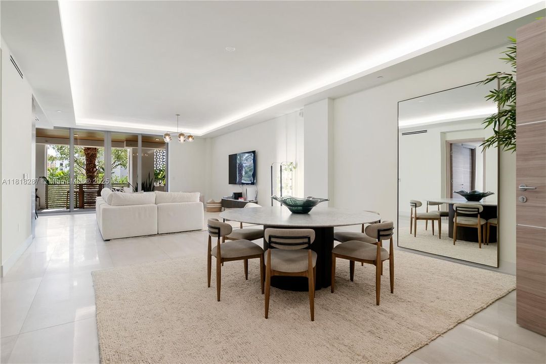 Modern dining room framed by clean lines and natural light, seamlessly connected to the living area.