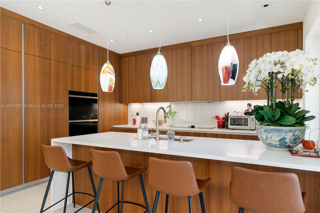 Extended island perfect for designer bar stools and statement lighting, ideal for morning coffee or casual entertaining.