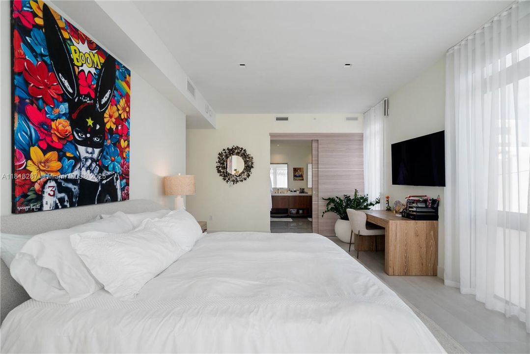 Spacious layout with room for a work area or additional furnishings, leading directly into the en-suite bathroom.