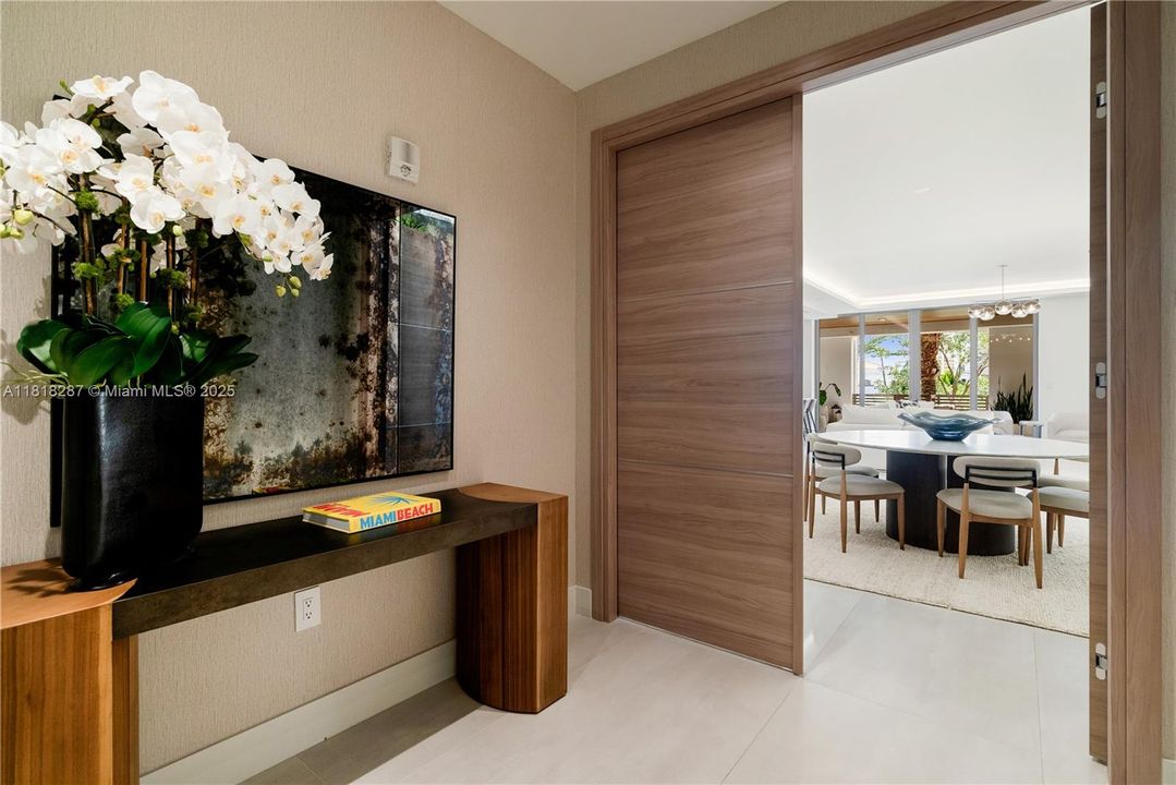 Refined entry hallway with natural textures, warm tones, and artful details leading into the main living area.