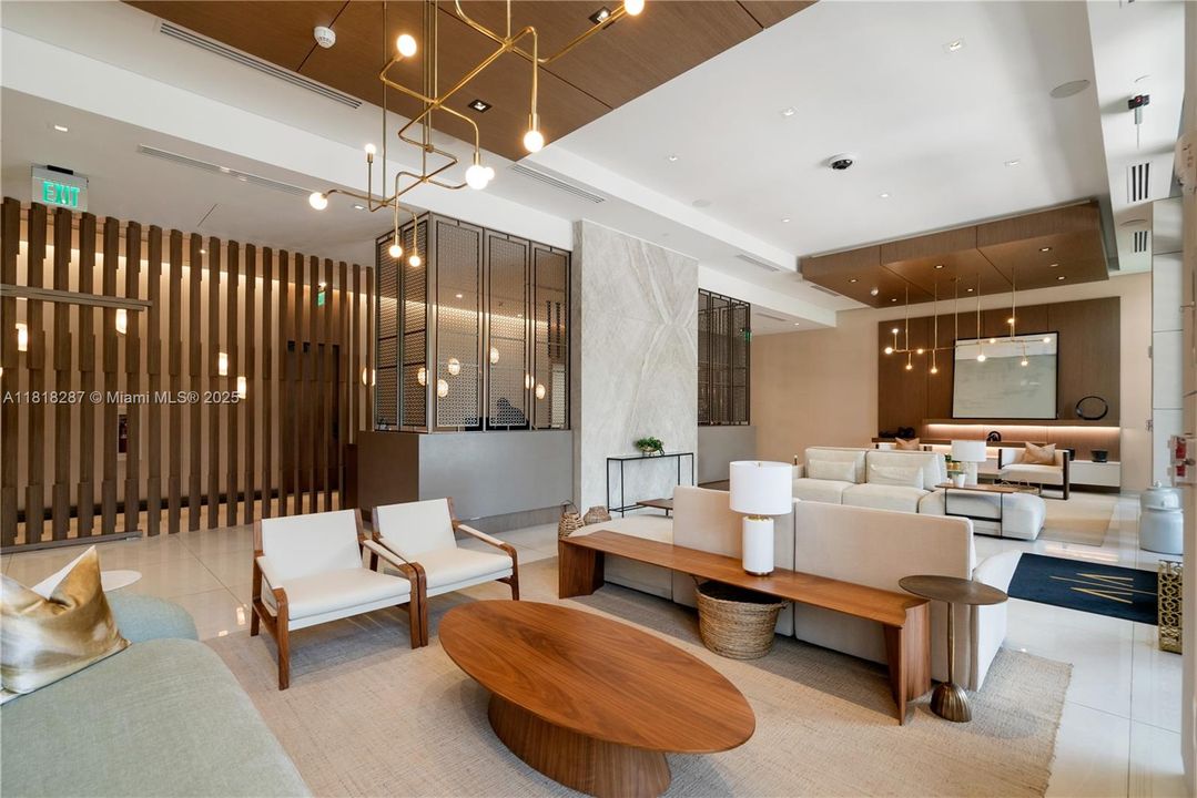 Open-concept lobby view highlighting fine architectural details, designer fixtures, and an airy, welcoming ambiance.