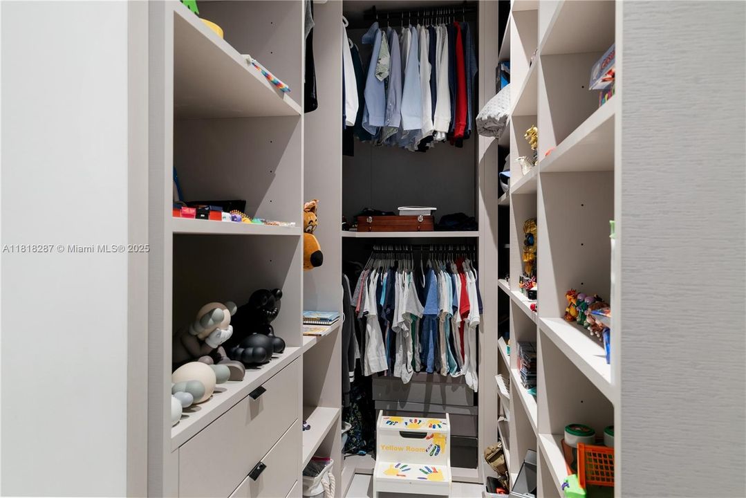 Custom closet with shelving, drawers, and ample storage.