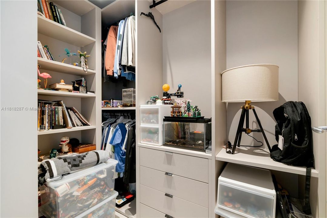 Custom closet with shelving, drawers, and ample storage.