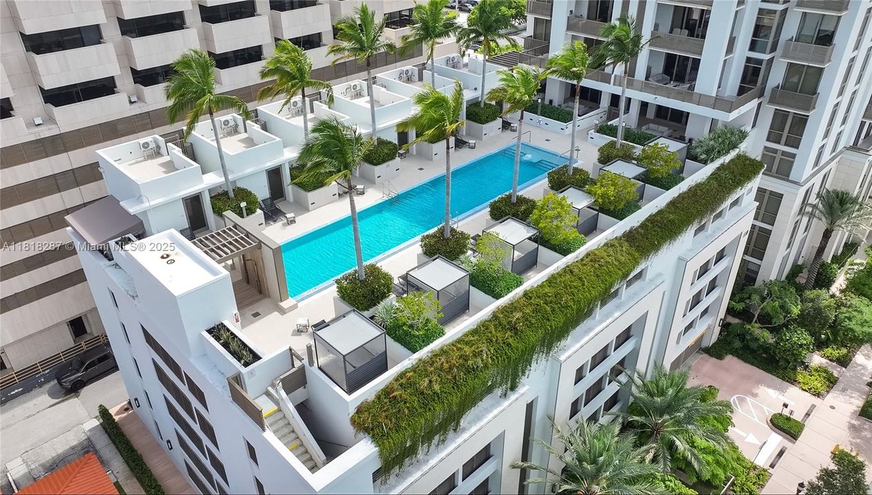 Pool deck with lounge seating and panoramic city views.