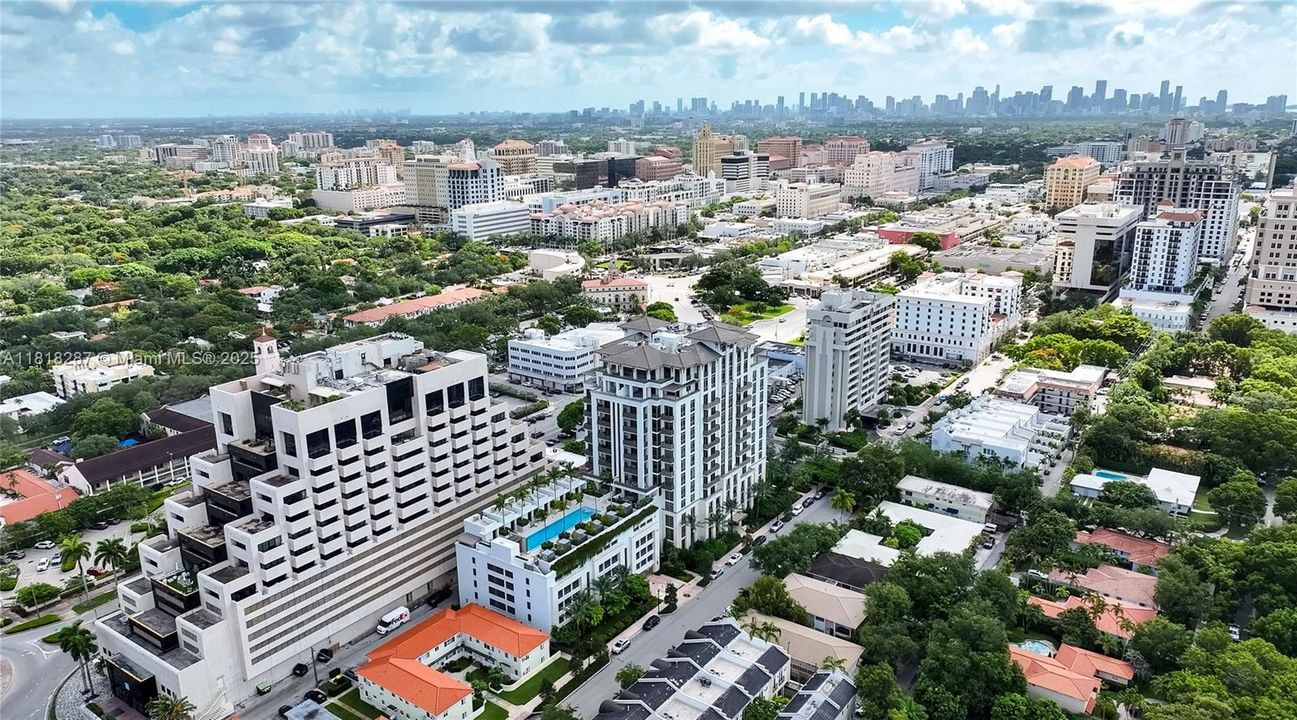 Exterior view highlighting the pool, landscaping, and surrounding residences.