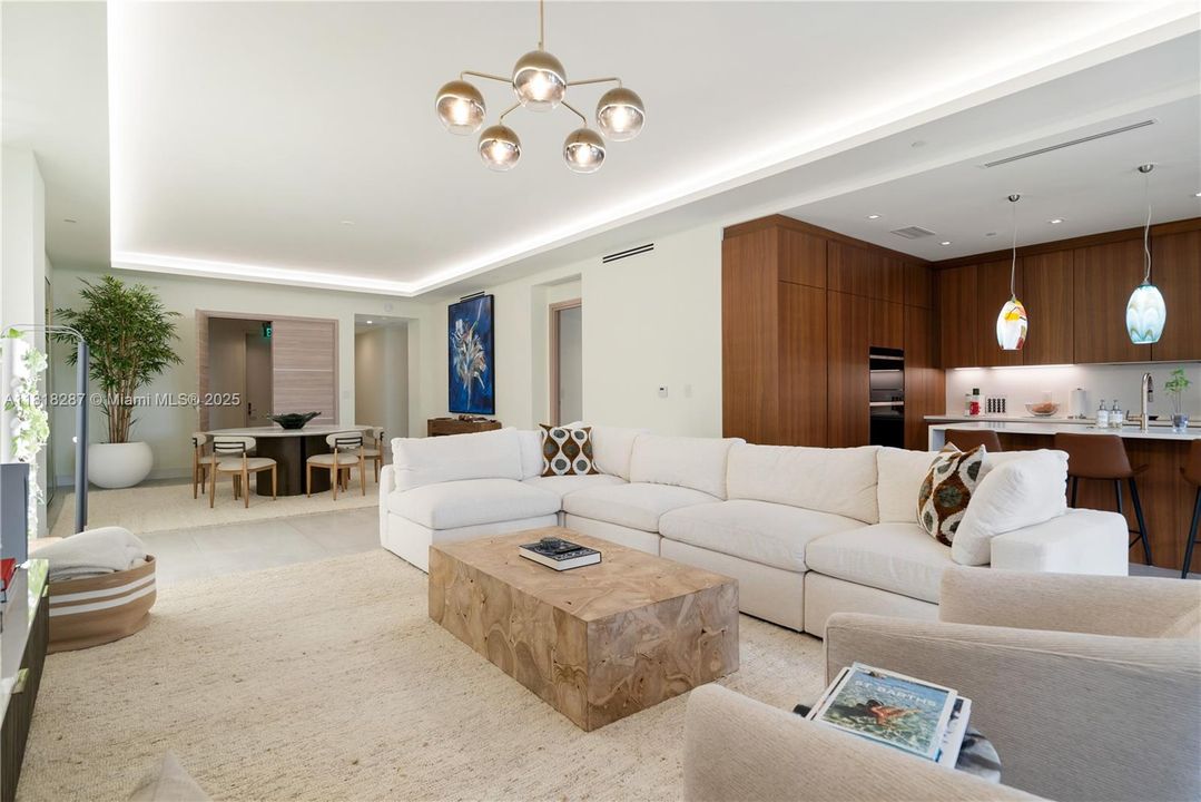 Spacious open living and dining layout with floor-to-ceiling windows and a neutral palette for a serene aesthetic.