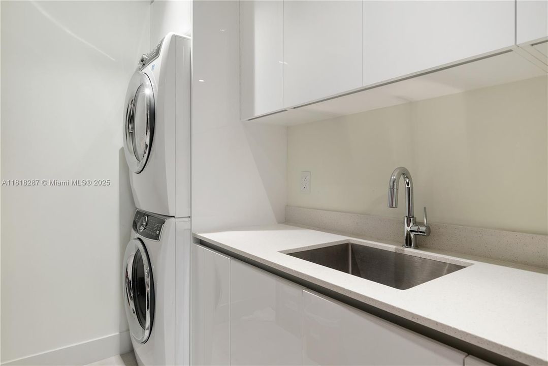 Dedicated laundry room with full-size washer/dryer and utility sink.