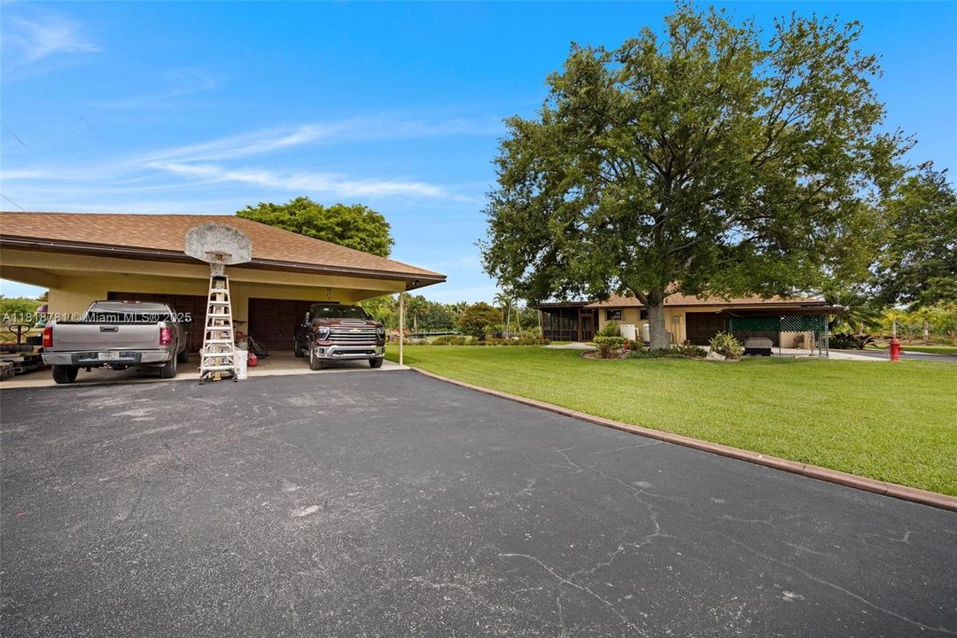 Detached 2 car carport with a 3 car garage and a/c office
