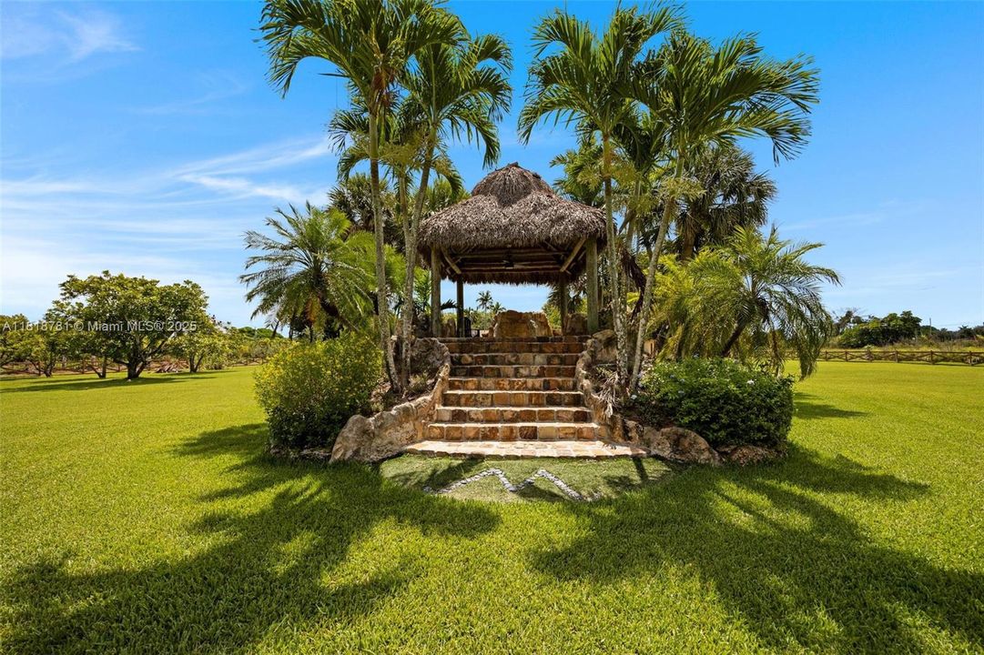 Chickee hut with built in pool slide and water fall