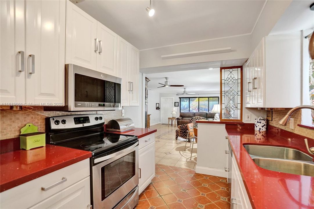 Beautiful spacious kitchen with granite countertops & entrance into garage.