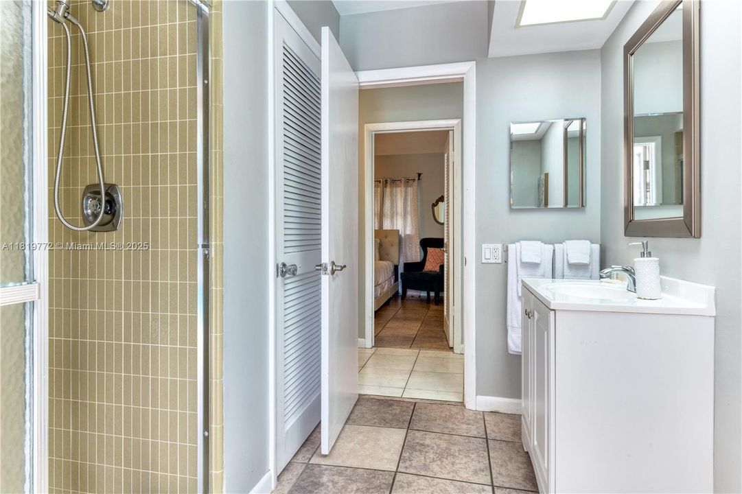 3rd Bathroom with a step-in shower, single vanity, and direct access to the pool deck