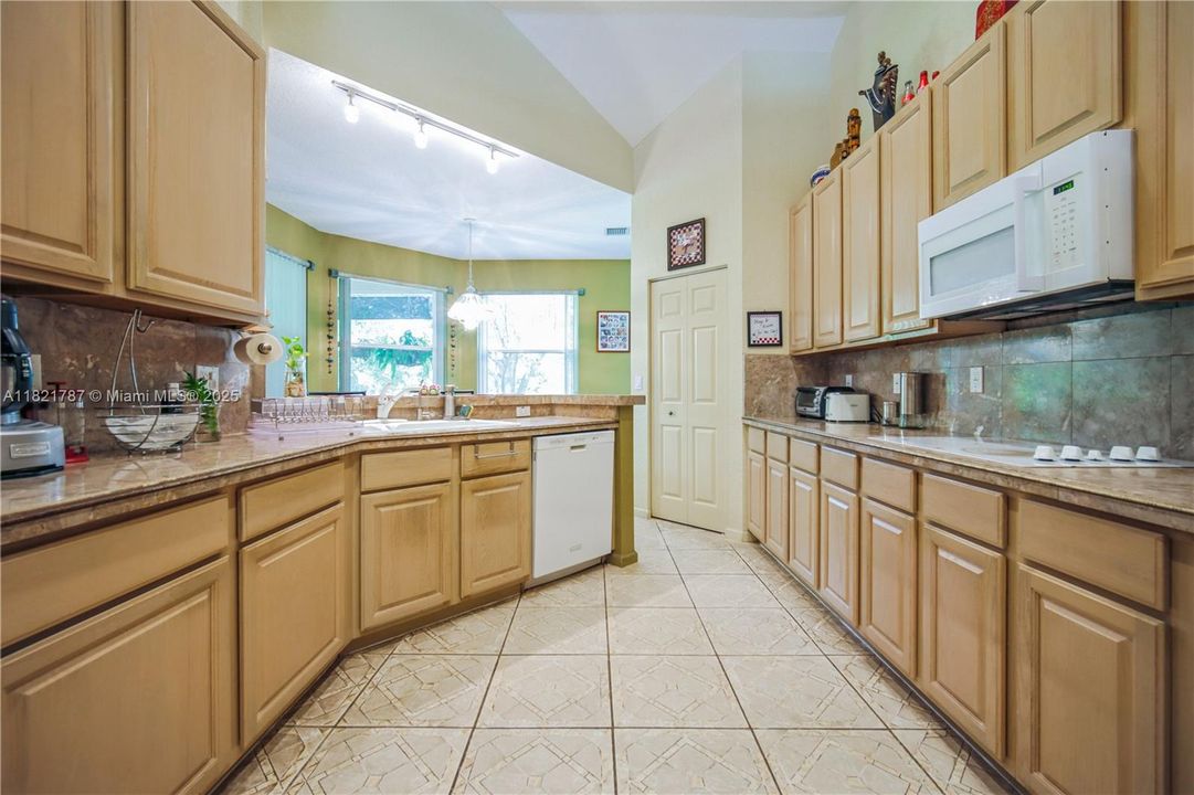 Large kitchen with dual ovens, many cabinets, lots of counter space, a pantry & a breakfast bar area too!