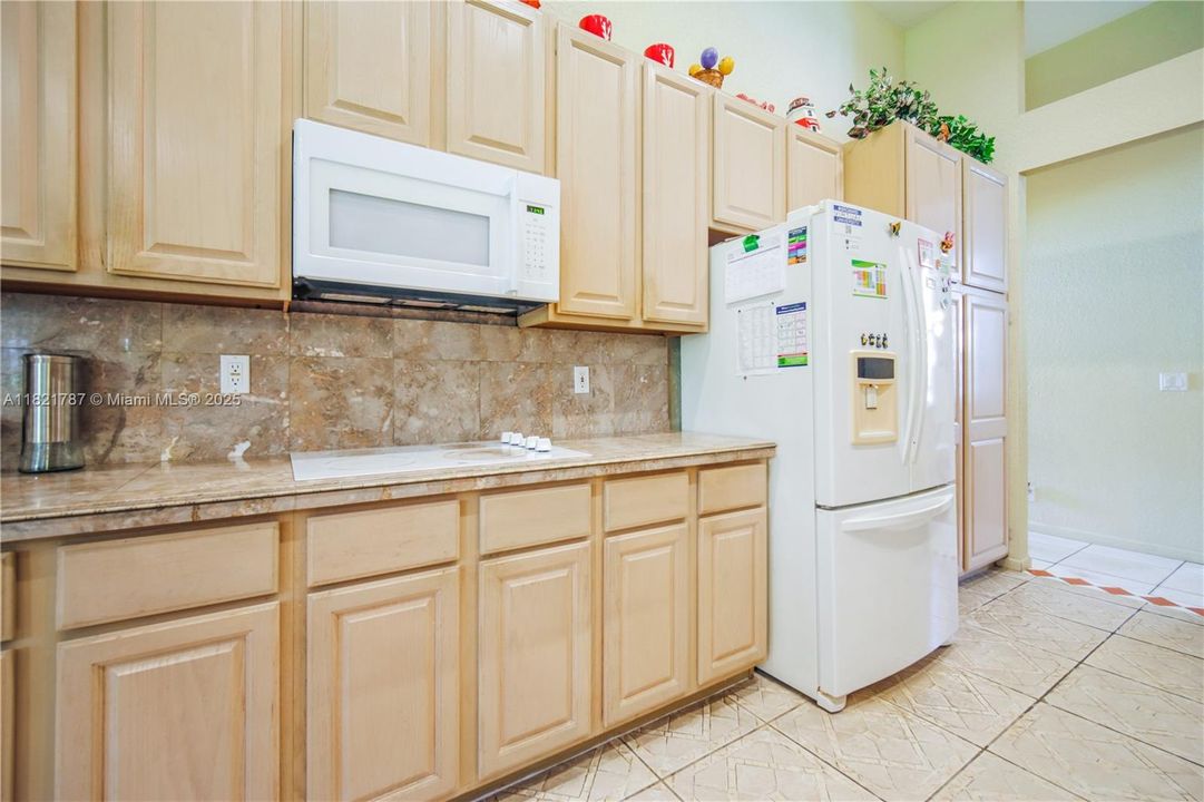 Large kitchen with dual ovens, many cabinets, lots of counter space, a pantry & a breakfast bar area too!