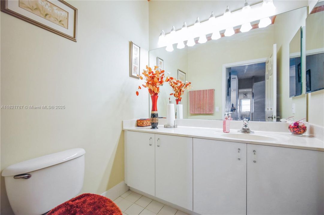 Half-bath located between office & primary bedroom entry.