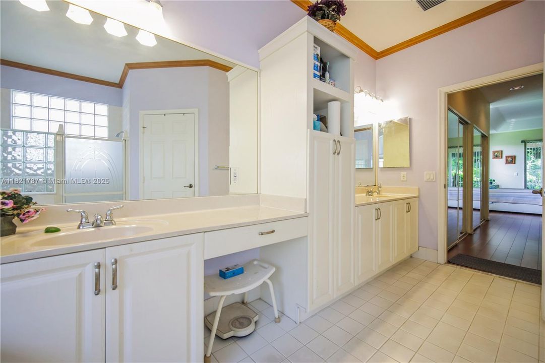 Spacious primary bathroom with dual sinks, jetted tub & separate shower.