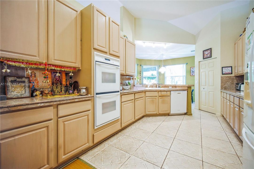 Large kitchen with dual ovens, many cabinets, lots of counter space, a pantry & a breakfast bar area too!