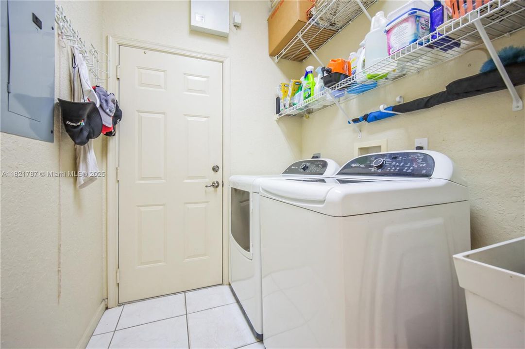 Laundry room with shelving & convenient utility tub.