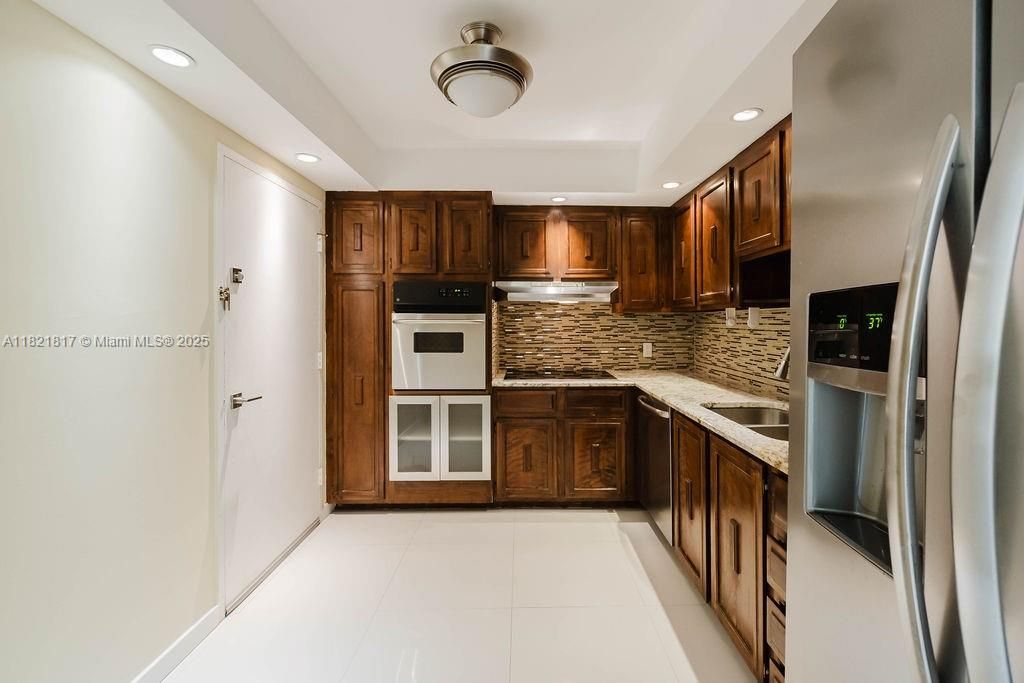 Modern kitchen with stainless steel appliances, granite countertops, and ample cabinetry — ideal for everyday cooking or hosting.